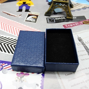 Detail of dark blue diamond-patterned jewelry box with black foam interior padding