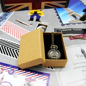 Vintage bronze pocket watch with Eiffel Tower cutout and kraft paper gift box