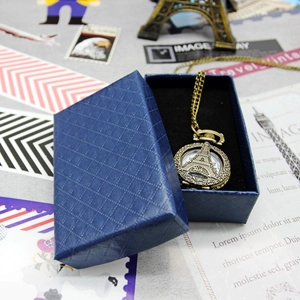 Vintage bronze pocket watch with Eiffel Tower design and textured blue gift box