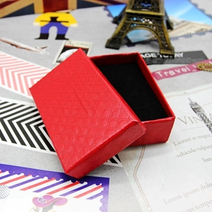 Detailed view of red jewelry box with diamond texture and black velvet interior