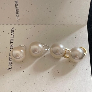 Minimalist 925 sterling silver pearl earrings in gold and silver finish on a textured card