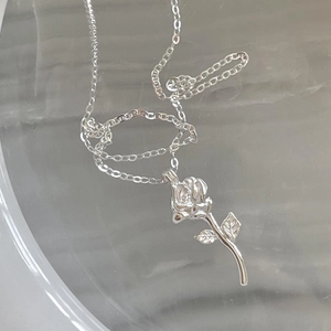 Minimalist 925 sterling silver rose necklace with realistic flower pendant on marble