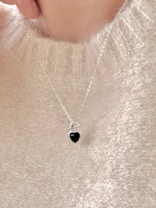 Close-up of 925 sterling silver necklace with black heart pendant and OT toggle clasp