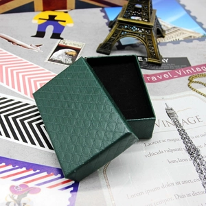 Detail of dark green diamond pattern jewelry box with elegant black velvet lining