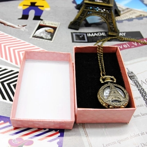 Vintage bronze pocket watch necklace with Eiffel Tower cutout in a pink jewelry gift box