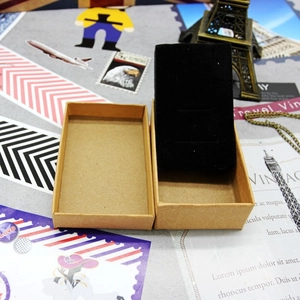 Detail of a brown kraft paper jewelry gift box with a black velvet interior foam insert