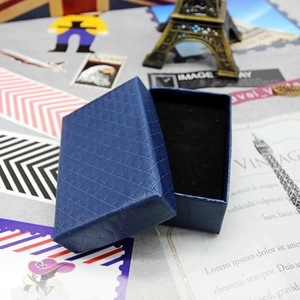 Detail of dark blue diamond pattern jewelry box with black velvet lining for necklaces