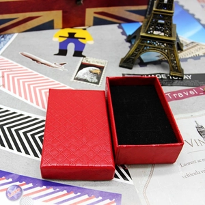 Detailed top view of red diamond pattern jewelry box with black velvet lining insert