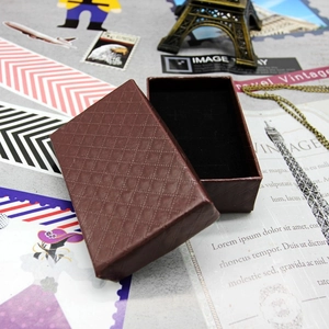 Vintage style brown jewelry box with diamond pattern texture and black velvet lining