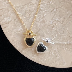 925 sterling silver heart necklace with black agate pendants on marble tray