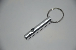 Macro shot of silver aluminum survival whistle with convenient key ring attachment