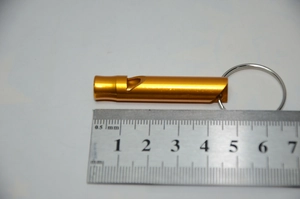 Detailed scale view of a golden aluminum emergency whistle measuring 4.7cm with keyring