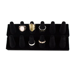 Detailed close-up of a premium black velvet tiered ring display with various jewelry samples