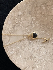 Detail of 925 silver gold heart necklace with black agate and elegant T-bar closure