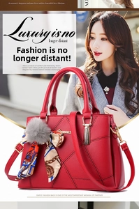 Detail of red quilted faux leather handbag with golden hardware and floral scarf accessory