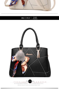 Detail of black handbag with geometric stitching, decorative scarf and fur ball charm