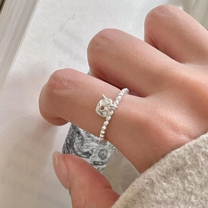 925 silver beaded ring featuring a delicate heart lock charm on a model's finger