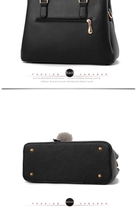 Detail view of black pebble leather bag showing back zipper pocket and metal bottom studs