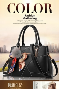 Detail of black leather handbag with white V-stitching, silk scarf and fur ball charm