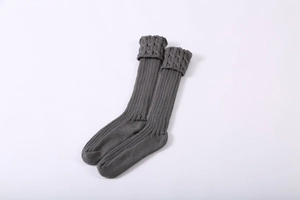 Detail of dark grey knit leg warmers with cable knit cuffs and ribbed texture