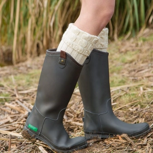 Knit leg warmers over grey rain boots featuring cable stitch and side buckle detail