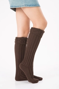 Detail shot of coffee brown knit leg warmers showing ribbed texture and cable knit patterns