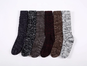 Close-up of thick cable knit winter socks in six assorted colors with ribbed texture