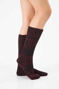 Close-up of thick knit Christmas floor socks in mixed black and red wool texture