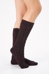 Close-up of cable knit wool socks featuring a vintage textured pattern in dark burgundy