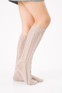 Detail of oatmeal cable knit leg warmers showing thick knit texture and cuff design