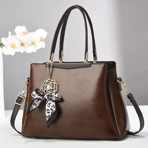Detailed view of the dark brown PU leather texture and stylish bow pendant decoration