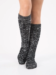 Detailed close-up of thick knit black and white textured winter socks with ribbed cuffs