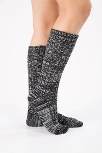 Close-up of thick grey chunky knit thermal winter socks with warm ribbed texture detail