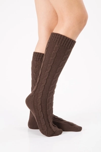 Close-up of deep brown cable-knit leg warmers showing detailed texture and ribbed cuffs
