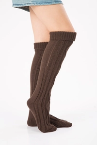 Detailed close-up of dark coffee cable-knit over-knee leg warmers with diamond pattern