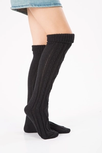 Close-up of black cable knit over-knee leg warmers showing detailed texture on a white background