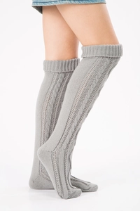 Detail shot of grey cable knit texture on over-knee warmers with visible ribbing