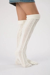 Detail showing white cable knit over-knee leg warmers with thick textured stitching pattern