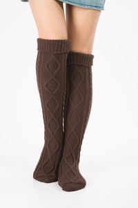 Detailed cable knit texture of dark brown over-knee leg warmers for autumn and winter
