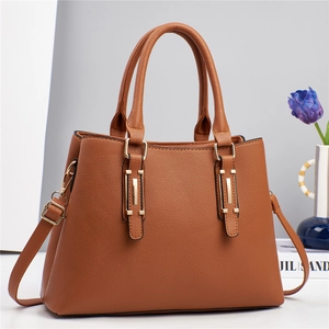 Elegant caramel brown textured leather handbag for women with gold hardware and strap