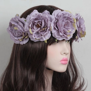 Detailed view of artificial purple rose headband for festivals on a mannequin head