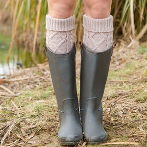 Chic beige cable knit leg warmers for women paired with tall rain boots in autumn