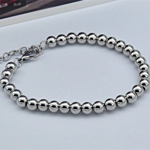Detailed close-up of stainless steel round bead bracelet with adjustable lobster clasp