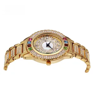 Detail view of gold luxury watch with colorful gemstones and white rhinestone bezel