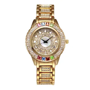 Close-up of golden watch dial featuring multi-colored gemstones and full crystal setting