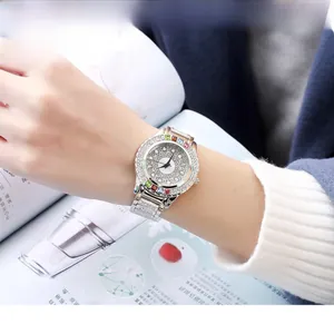 Detail showing the colorful rainbow gemstone markers and diamond bezel on silver luxury watch