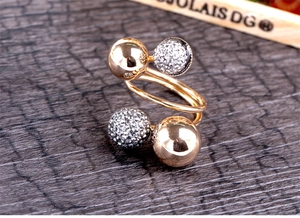 Macro view of double-layered rose gold ring with polished metal and rhinestone beads