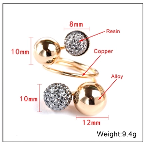 Detailed view of gold spiral ring with polished beads and resin glitter spheres