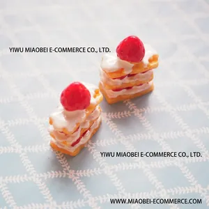 Top view of two realistic resin strawberry cream layered cake miniatures for DIY jewelry