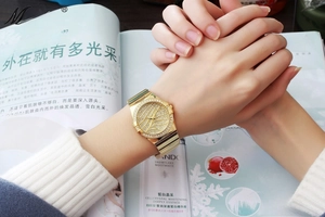Macro shot of gold-plated stainless steel watch with full diamond dial and octagonal case